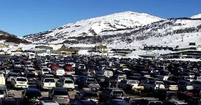 Snow car parks full, banked up traffic and crash cause delays