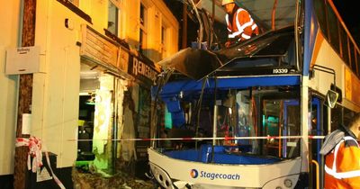 Video shows damaged bus being carefully removed after smashing into building