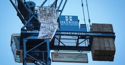 A man has been staging protest on top of a crane in Salford since 5AM - and says he could be there for 'weeks'