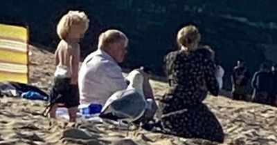 Boris Johnson suns himself on beach with family as travel chaos rages across Britain