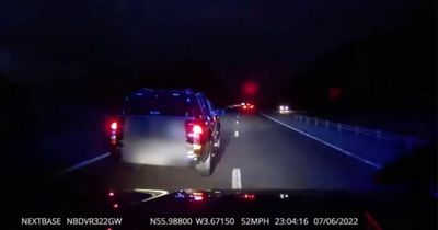 Driver swerves across road while 'using mobile phone' on M9 in police car footage