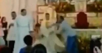 Moment groom charges through church and throws punch at priest who refused to marry him