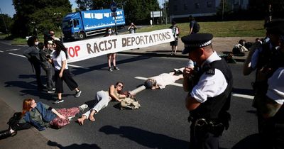 Rwanda flight protesters lie in road and lock themselves together to block deportation