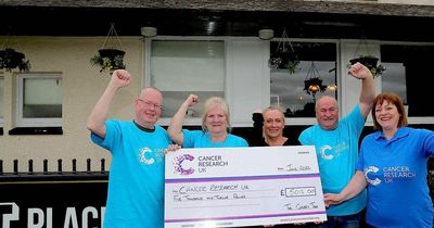 Wishaw pub staff and regulars hand over huge cheque to cancer charity