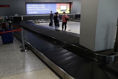 Bumpy start to holidays for travellers as Qantas staff shortage leads to luggage lag