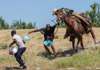 Brutal image of Haitian refugee being chased by mounted border agent minted on memorial coin
