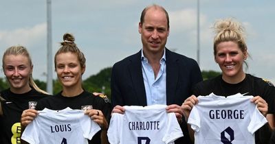 Prince William beams as he's given football shirts for Louis, George and Charlotte