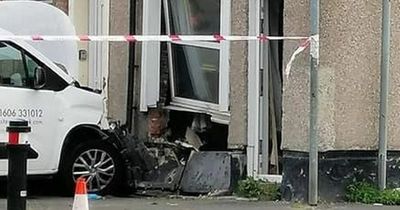 Man 'cut from car' after van smashes into house in Heywood