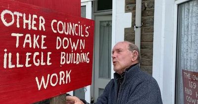 Pensioner drills holes into neighbour's wall because he claims it is two inches into his garden