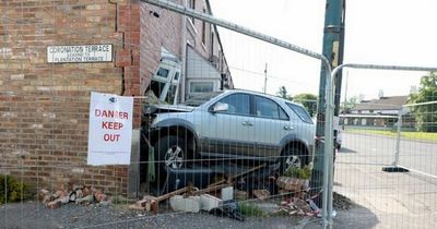 Car 'loses control' and ploughs into house as crash leaves two in hospital