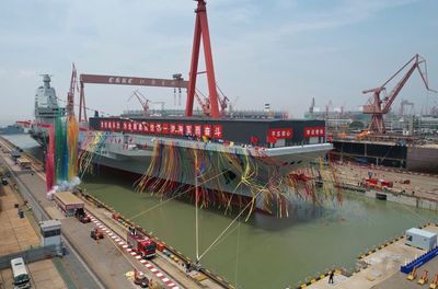 China launches high-tech aircraft carrier in naval milestone