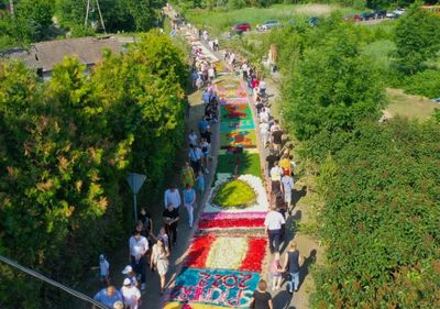 Poles carpet streets with flowers for Corpus Christi