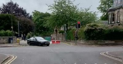 Edinburgh driver goes through red light and road closure after mounting kerb