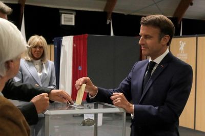 Macron battles French left in tight parliament election