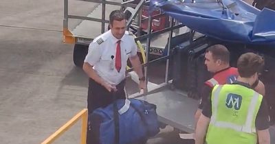 Pilot helps ground crew load luggage on plane as travel chaos continues at UK airports