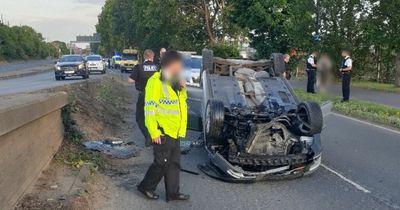 Dad arrested after car overturns with kids inside