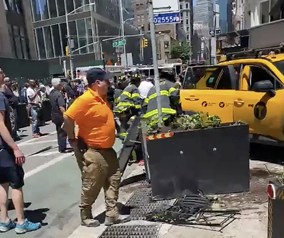 20 New Yorkers try to lift taxi after it jumped curb and pinned two women against a wall: ‘A remarkable scene’