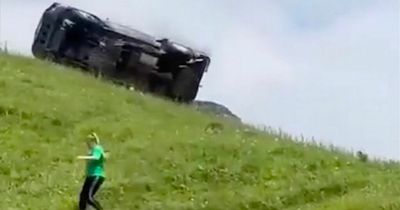 Tourists run for their lives as out-of-control car somersaults down steep hill