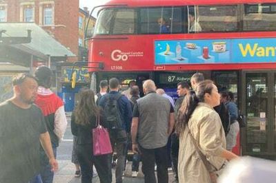 Tube strike fury boils over as irate commuter stands in front of bus and demands driver opens doors