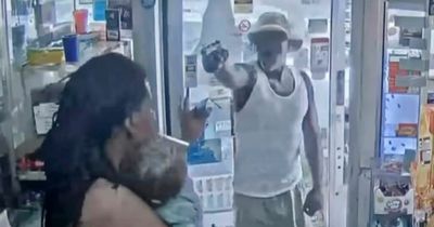 Gunman caught on CCTV as he storms petrol station and targets man cradling baby