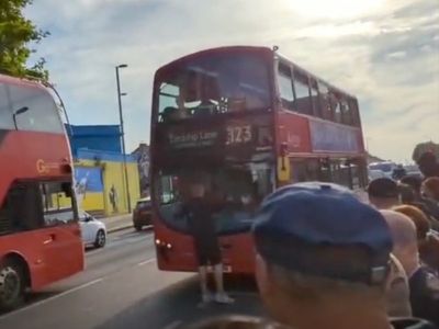 Angry commuter blocks bus too full to stop for new passengers during rail strike