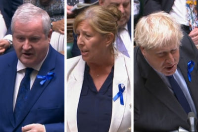 Why are MPs at Westminster wearing blue ribbons at PMQs?