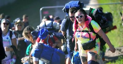 Glastonbury 2022 campers use wheelie bins and wheelbarrows to bring take their belongings on site