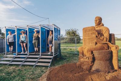 Huge mud toilet sculpture unveiled at Glastonbury to warn against climate change