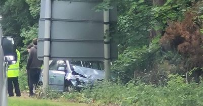 Car smashes into street sign on busy Scots road as cops race to scene