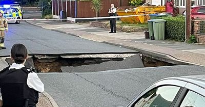 Shocking 25ft sinkhole swallows part of London street taking motorcycle with it