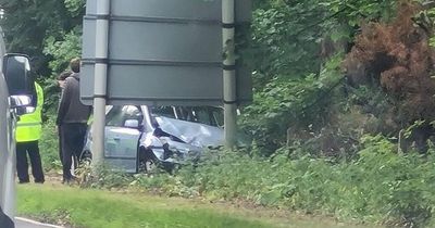 Car smashes into sign on busy Scottish road as cops race to the incident