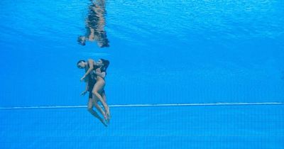 Dramatic moment swimmer is rescued from bottom of pool after fainting during championships