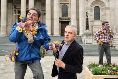 Rowan Atkinson poses with flower sculpture of himself to help endangered bees