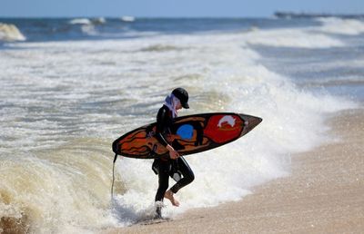 Swimming and surfing, Gazans savour a cleaner sea
