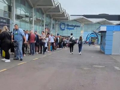Queues stretch all the way outside Birmingham airport this morning as air travel woes continue