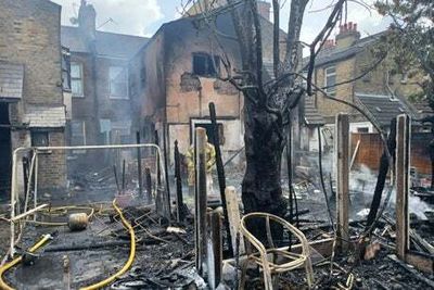 Woman injured as huge fire rips through gardens in east London