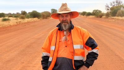 Shire of Laverton grader travels WA's most isolated roads with Jimi Hendrix and dingoes for company