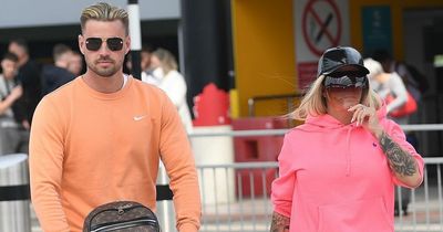 Katie Price and fiancé Carl Woods jet off on holiday after she avoids jail time
