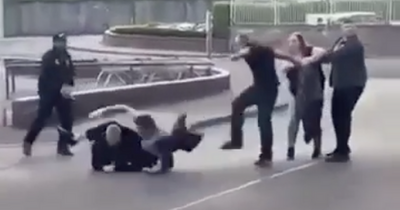 Scots supermarket brawl sees woman knocked to ground as men punch and kick each other in street