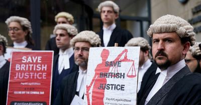 Tearful barristers cry on picket line outside court as they walk out in row over pay