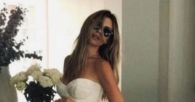 Abbey Clancy tries on her stunning wedding dress to celebrate Peter Crouch anniversary