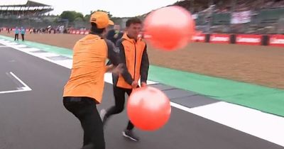 Daniel Ricciardo throws space hopper in Lando Norris' face as drivers race at Silverstone