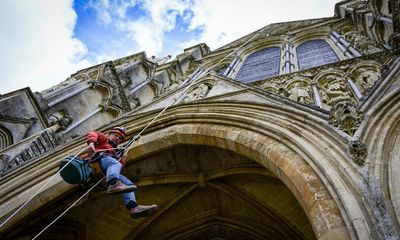 ‘It’s quite a commute’: climbers scale Salisbury Cathedral to repair stonework