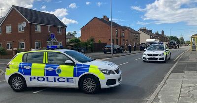 Road closed and men injured after pickup truck and van smash