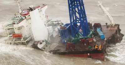 Dozens feared dead after huge ship snaps in two and sinks in storm off Hong Kong