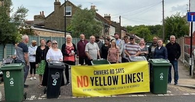 Furious residents use wheelie bins to stop council painting yellow lines on their street