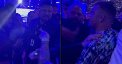 Dustin Poirier and Michael Chandler separated by security after cageside row at UFC 276