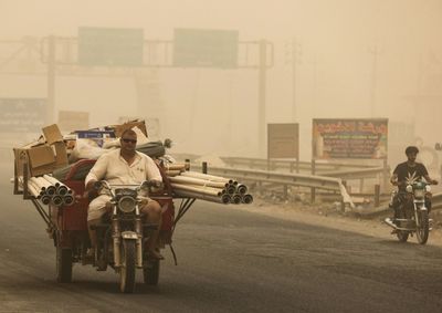 Weathering sandstorms, Iraqis grit teeth and battle on