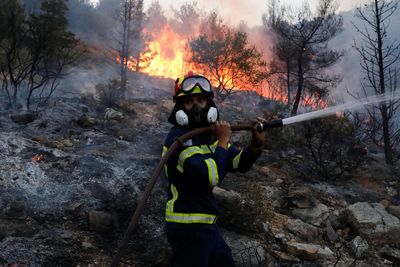 Wildfire rages north of Athens, one town evacuated