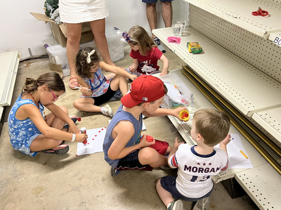 Heartbreaking photo shows children colouring on shop floor as they hide from active shooter in Highland Park